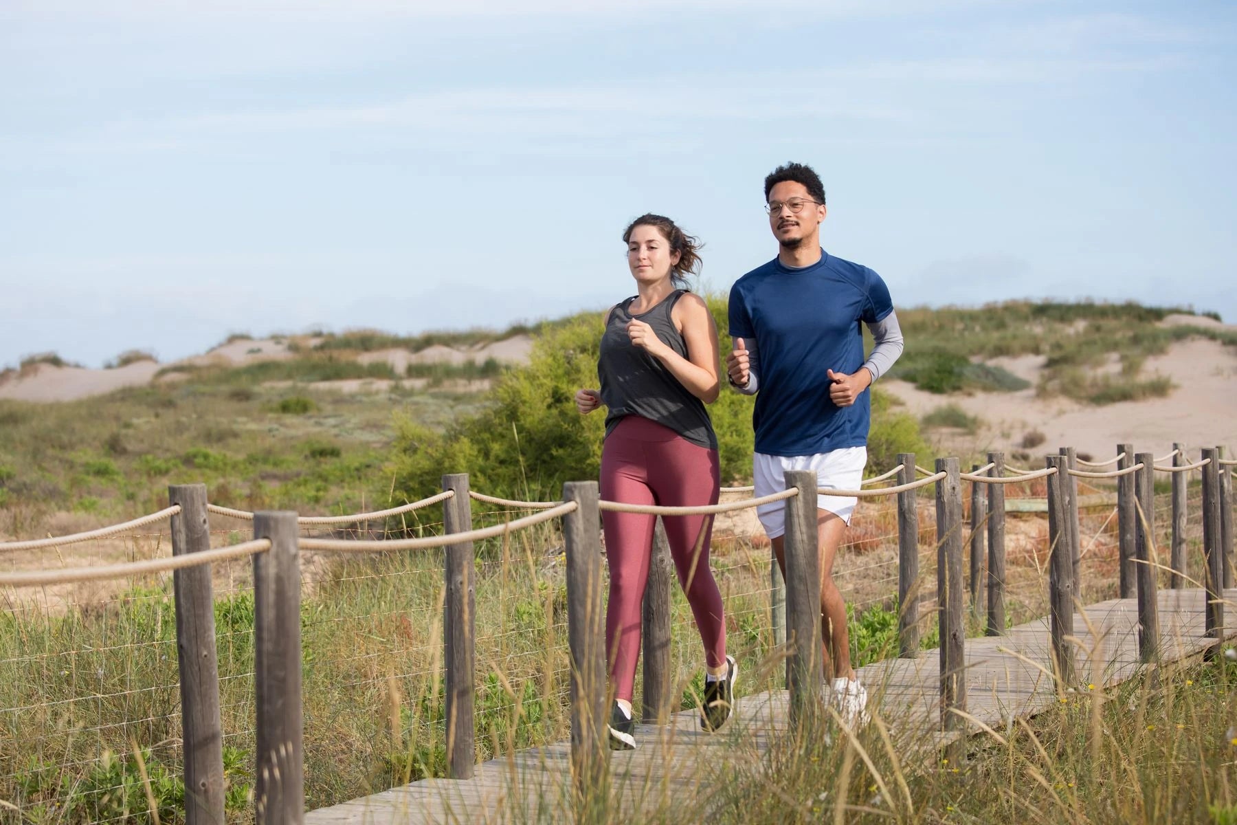 Two people jogging beside the coast